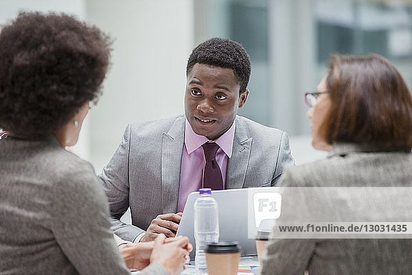 Businessman listening to colleagues in meeting