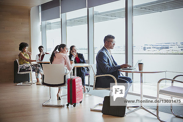 Business people working in airport business lounge