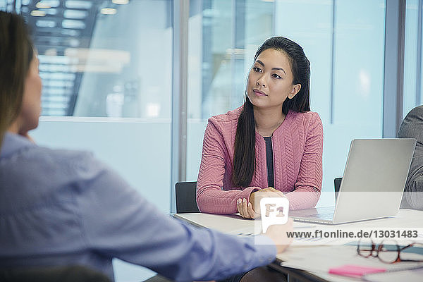 Attentive businesswoman listening in conference room meeting