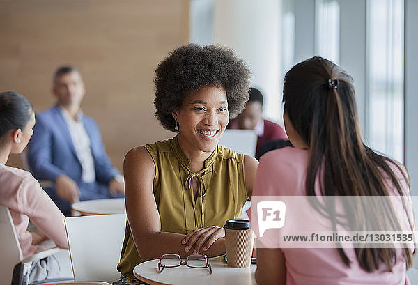 Smiling businesswomen enjoying coffee break