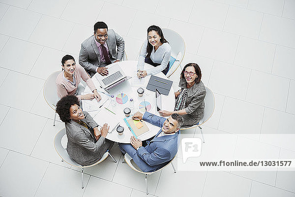 High angle portrait smiling  confident business people meeting at round table