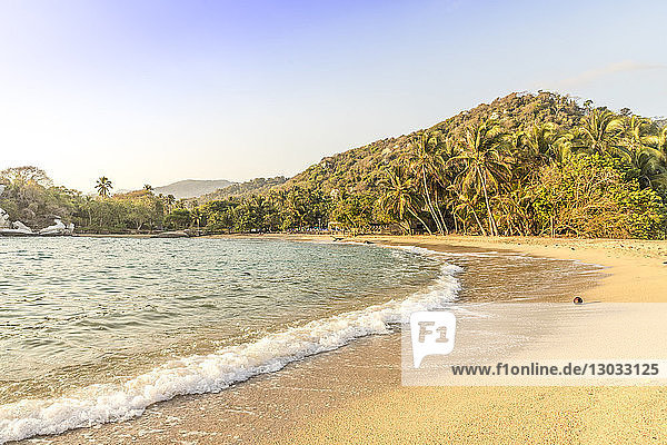 A view of a beach and the Caribbean sea in Tayrona National Park  Colombia