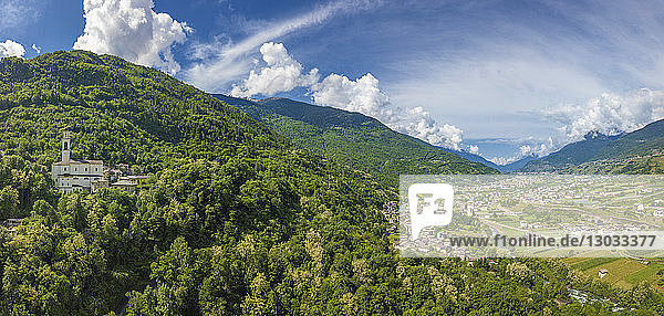 Aerial view of church and green hills around Sazzo  Ponte In Valtellina  Sondrio province  Lombardy  Italy