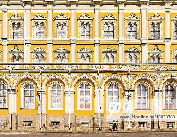 Two women walking in the Kremlin in front of Grand Kremlin Palace UNESCO World Heritage Site Moscow Russia