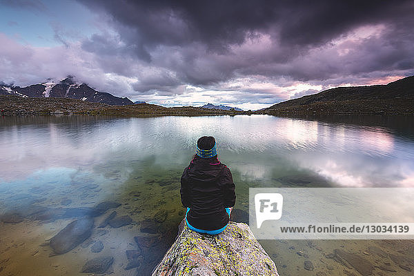 Girl by the Manzina lake at sunset Valfurva Valtellina Lombardy Italy