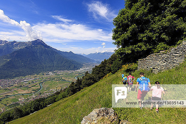 Family with children walk on footpath to Alpe Bassetta  Lower Valtellina  Sondrio province  Lombardy  Italy