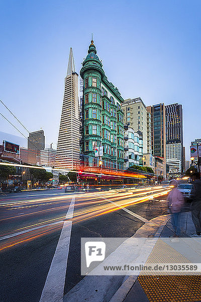View of Transamerica Pyramid building on Columbus Avenue and car trail lights  San Francisco  California  United States of America  North America