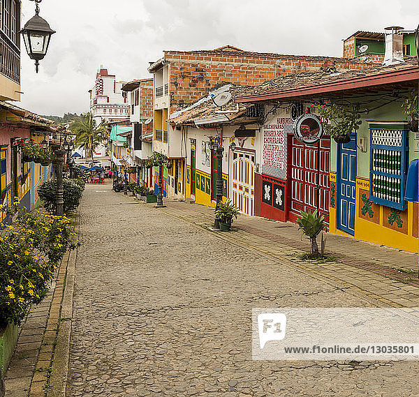 A typically colourful street with buildings covered in traditional local tiles in the picturesque town of Guatape  Colombia