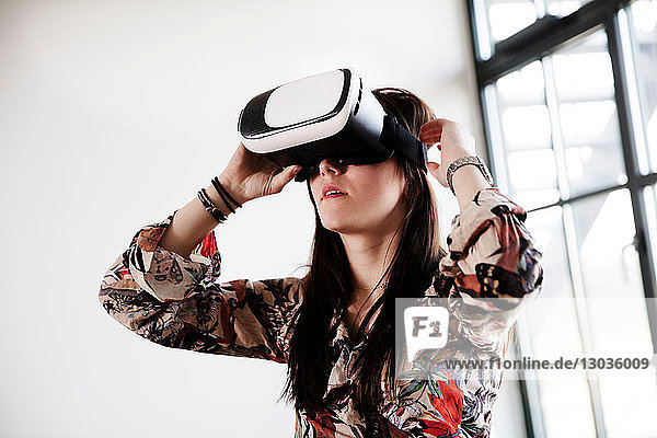 Teenage girl looking through virtual reality handset
