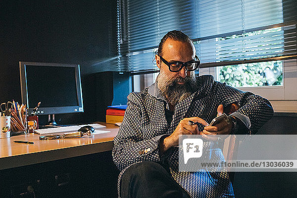 Man using cellphone at desk