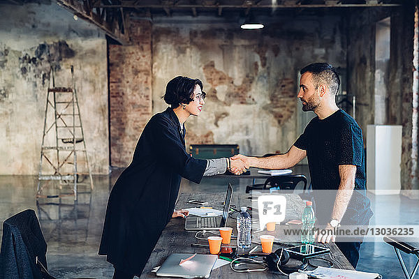 Business people shaking hands in studio