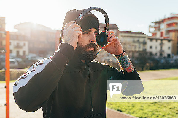 Man in hoodie using headphones