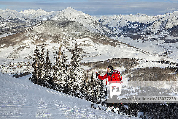 Side view shot of a woman skiing up a hill  Crested Butte  Colorado  USA