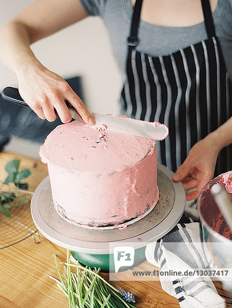 Woman preparing a raspberry and chocolate cake