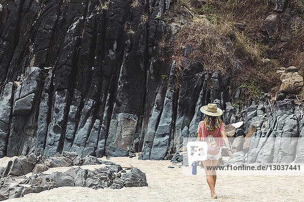 RÃ?ckansicht eines weiblichen Touristen  der am Strand spazieren geht  â€žKutaâ€œ  Lombok  Indonesien