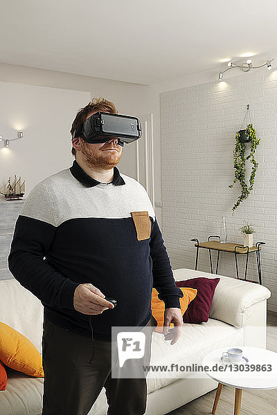 Man looking through virtual reality simulator at home
