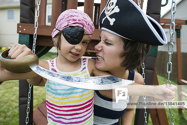 Mother and daughter in pirates costumes playing at playground
