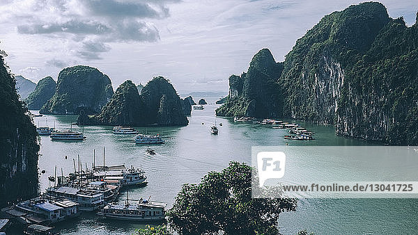 High angle view of boats moored at Halong bay by mountains against sky