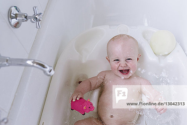 Portrait of happy baby girl in bathtub