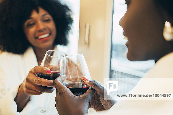 Close-up of businesswomen toasting wine in hotel room