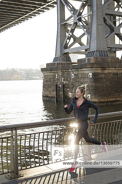 Zuversichtlicher Athlet läuft auf der Promenade am East River