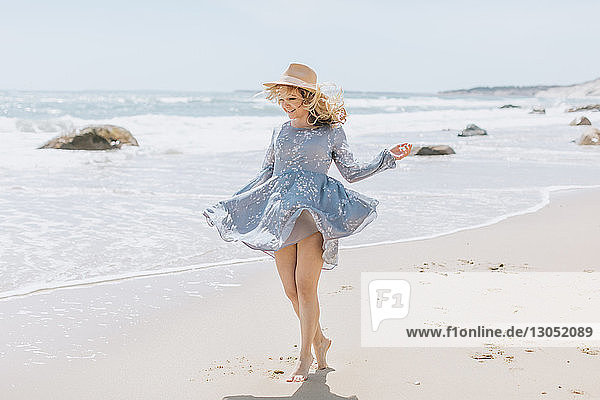 Junge Frau tanzt am windigen Strand, Menemsha, Martha's Vineyard, Massachusetts, USA