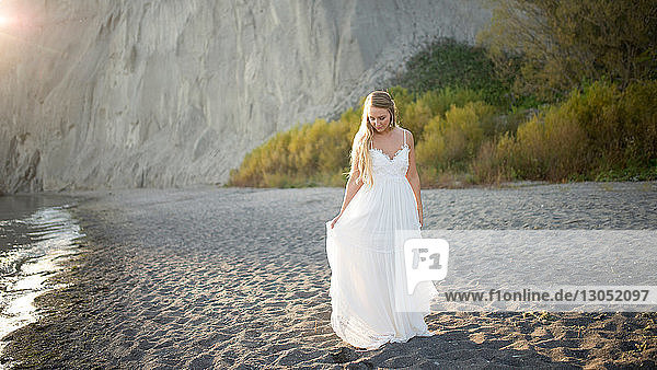 Bride in wedding dress on beach at sunset Scarborough Bluffs Toronto Canada