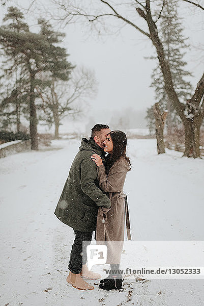 Couple hugging in snowy landscape  Georgetown  Canada
