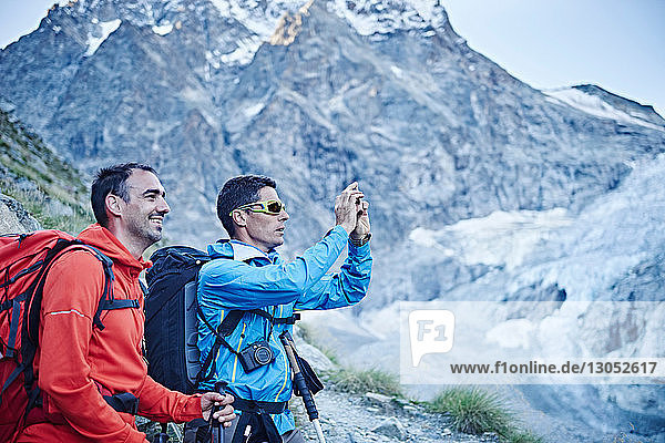 Hikers taking photograph  Mont Cervin  Matterhorn  Valais  Switzerland