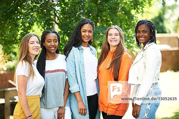 Five young women  higher education students on college campus  portrait