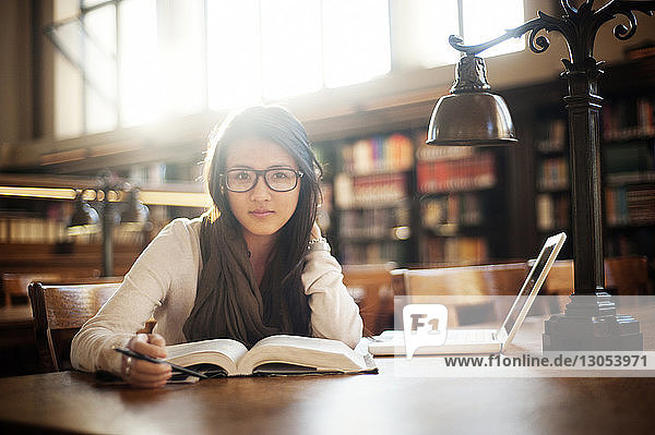 Portrait of woman sitting in library