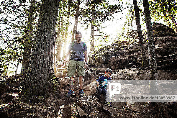 Father and son hiking in forest