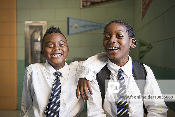 Portrait of happy schoolboys in classroom