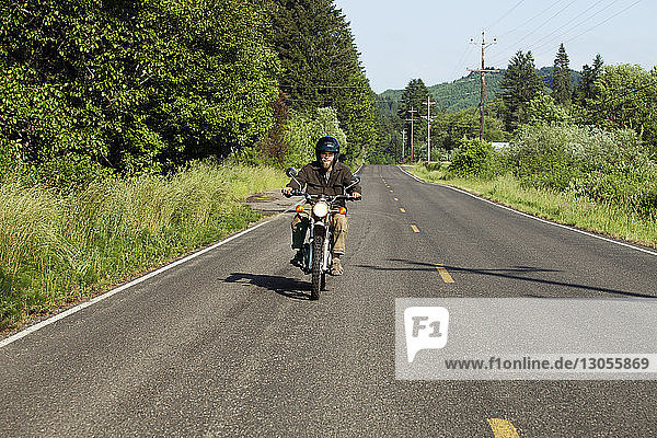 Man riding motorcycle on road