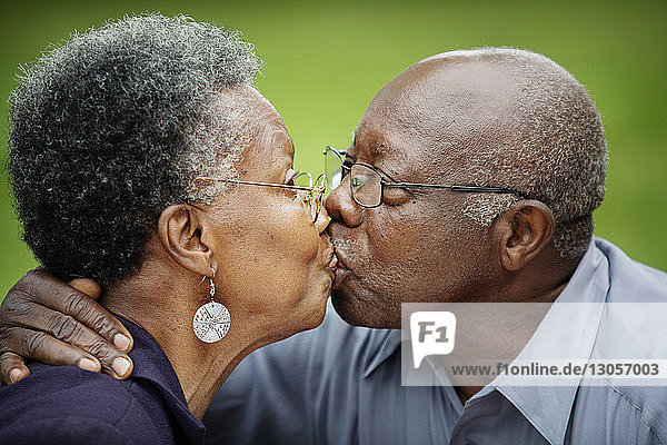 Close-up of senior couple kissing in backyard