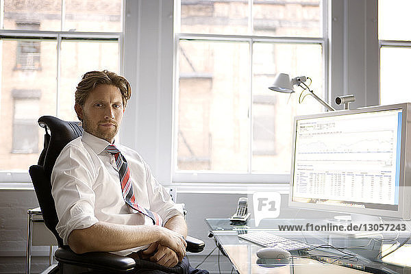 Portrait of businessman sitting at office
