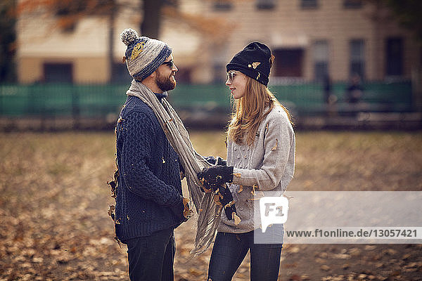 Side view of couple standing in park
