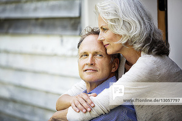 Close-up of senior woman embracing man