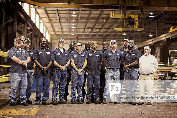 Portrait of coworkers standing in industry