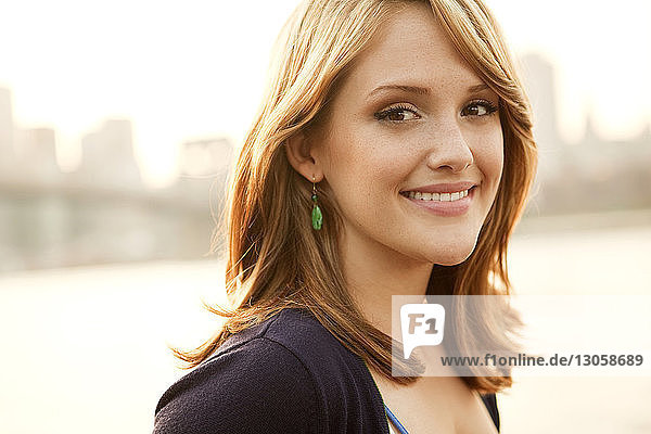 Portrait of smiling beautiful woman on sunny day