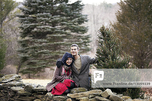 Portrait of happy couple in forest during winter