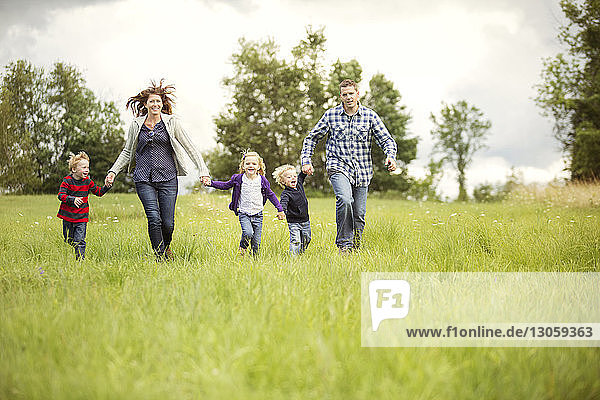 Happy family enjoying on grassy field
