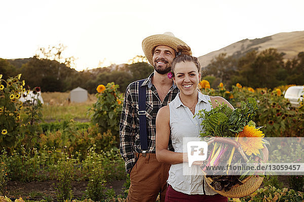 Smiling couple standing in farm