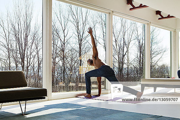Man practicing yoga at home