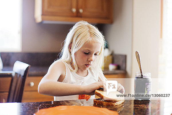Girl preparing breakfast in kitchen