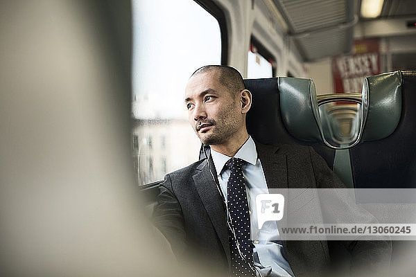 Thoughtful businessman traveling in train