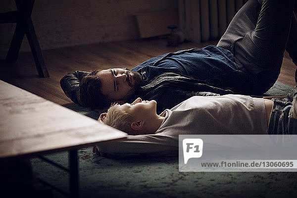 Couple relaxing on floor at home