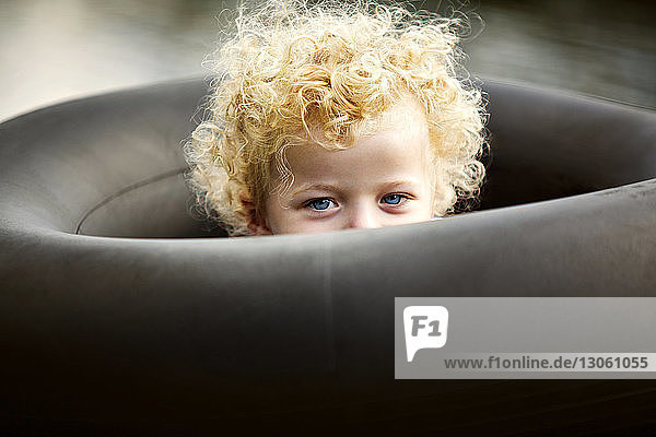 Portrait of boy amidst black inflatable ring