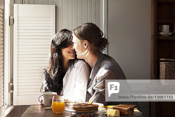 Smiling couple at breakfast table