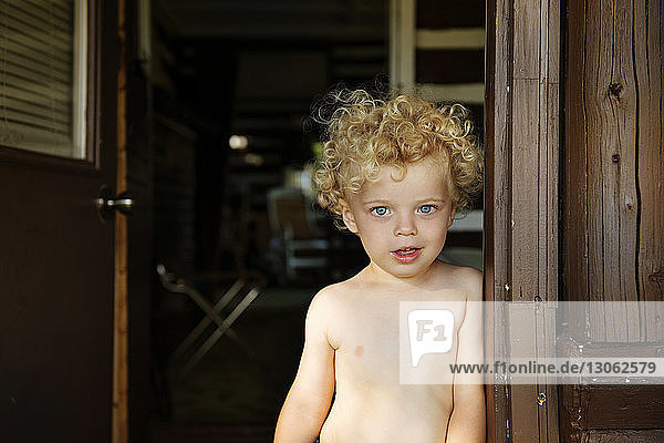 Portrait of boy on wooden doorway